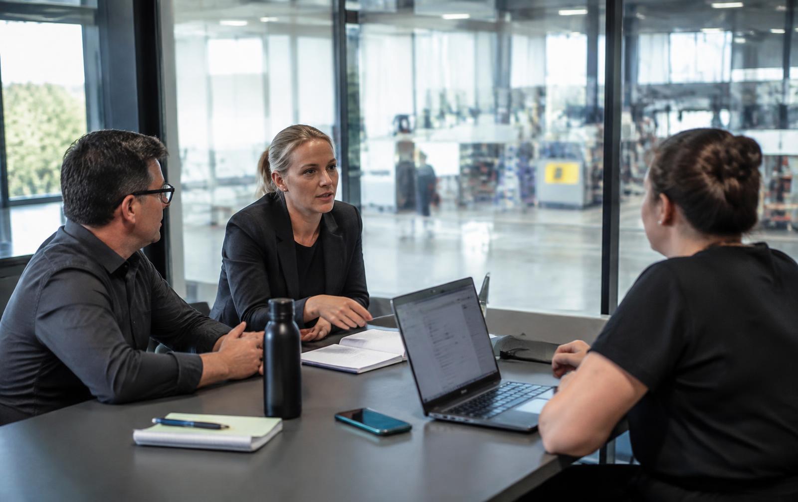 A small team in discussion in a modern workplace